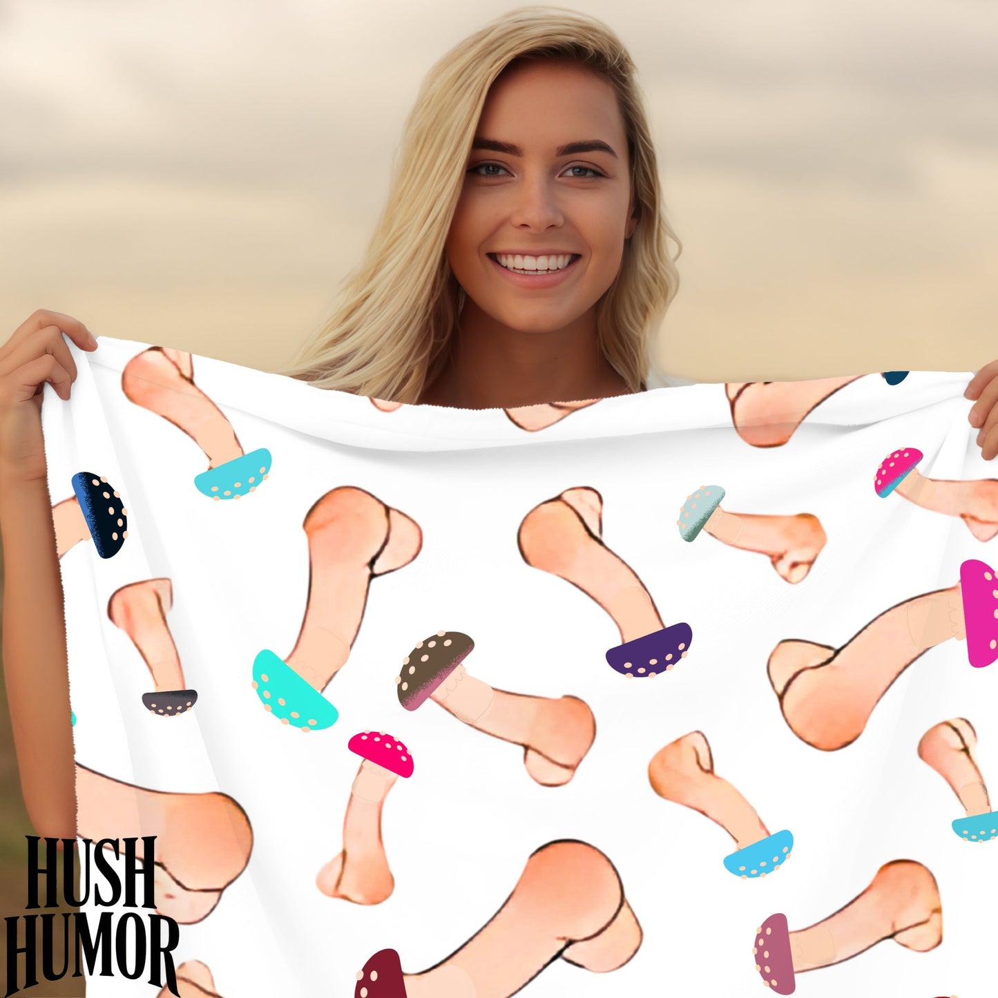 Woman holding a towel with cartoon penis pattern against a blurred natural background