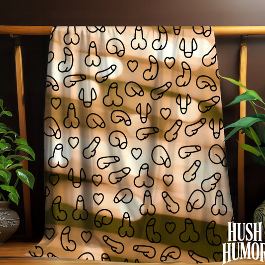 Blanket with black abstract penis and heart patterns on a wooden rack with plants and a pot below.