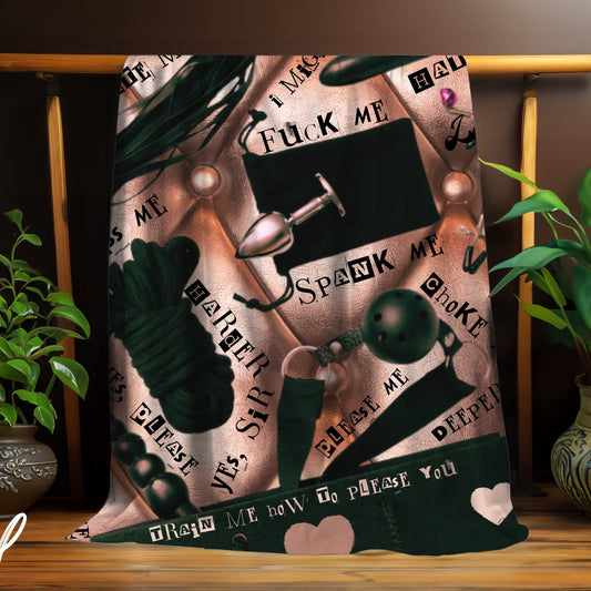 Decorative blanket with graphic BDSM themed designs and text on a wooden stand with plants.
