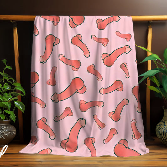 Pink blanket with red abstract penis's draped over a wooden rack, surrounded by plants.