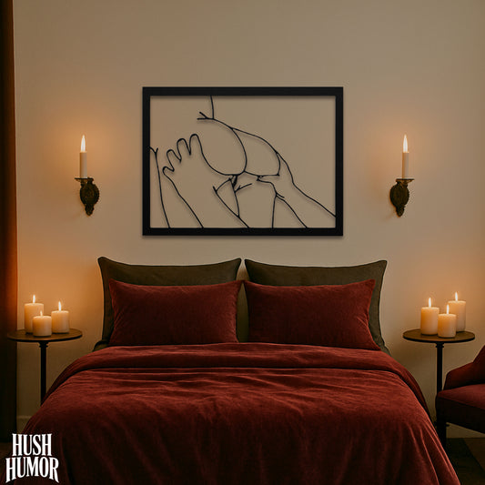 Bedroom with red bedding, candles, and a framed abstract artwork on the wall.